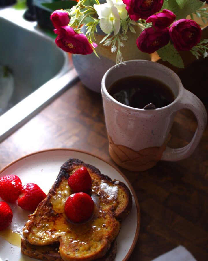French toast and coffee on ceramic pottery plate and cup