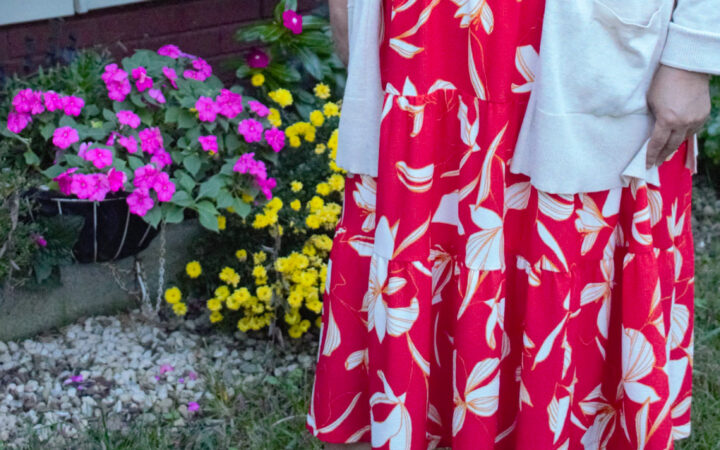 woman standing in the garden in an orange dress