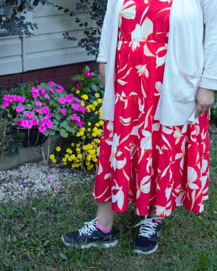 woman standing in the garden in an orange dress