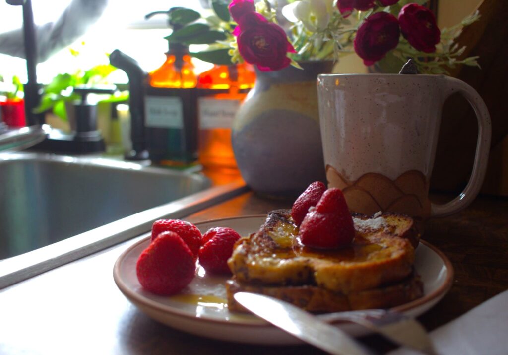 French toast on ceramic plate by the kitchen window