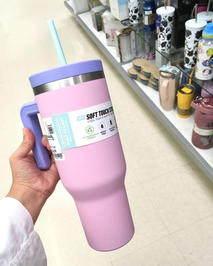 woman holding a pink tumbler