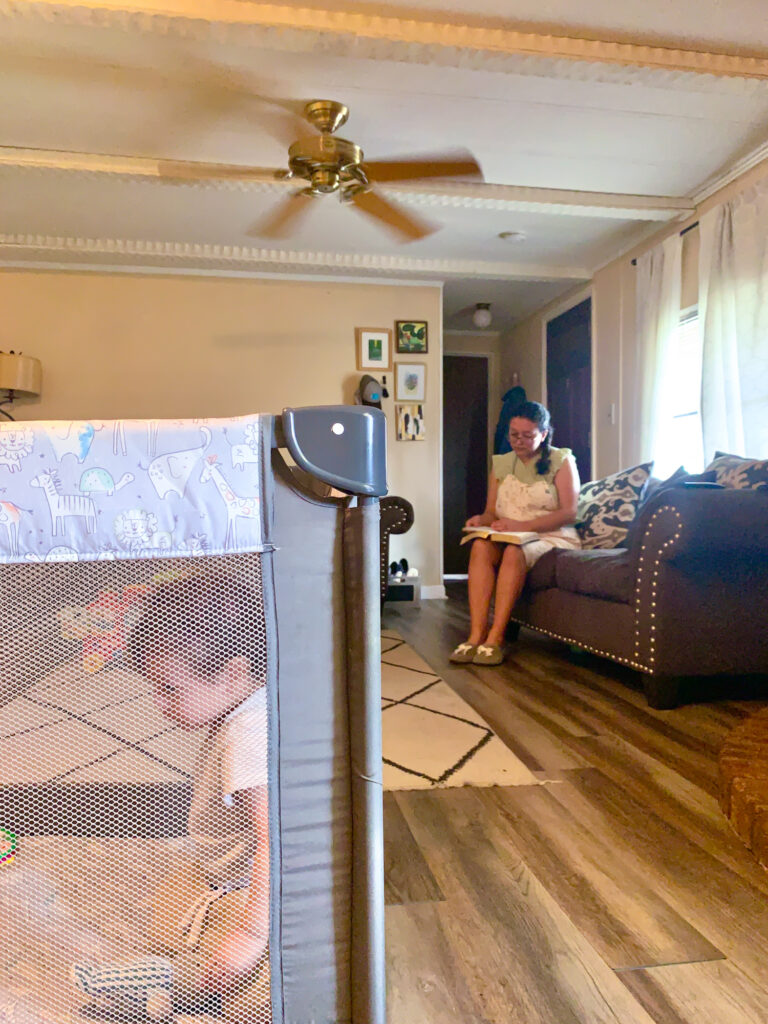 baby in the playpen and mom reading the Bible