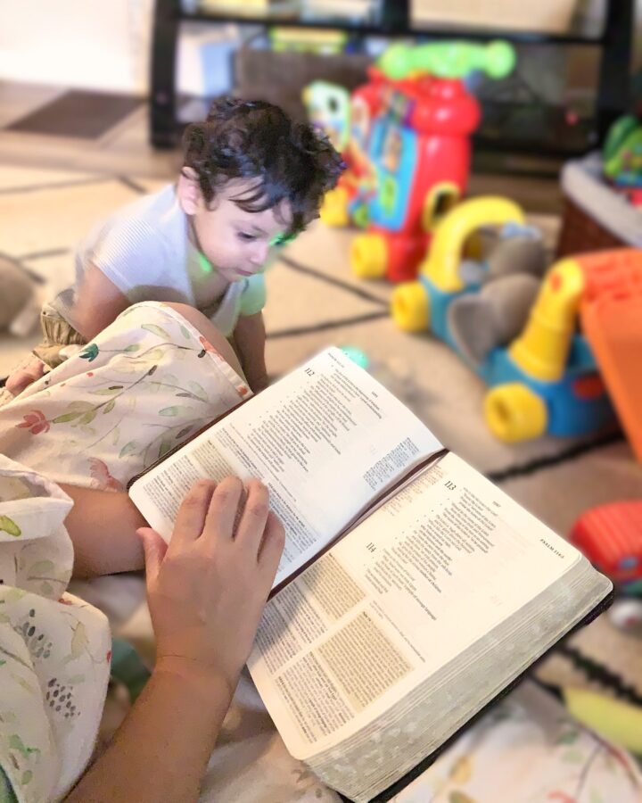 mom and baby playing on the floor and reading the bible