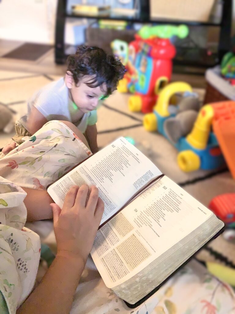 mom and baby playing and reading the bible