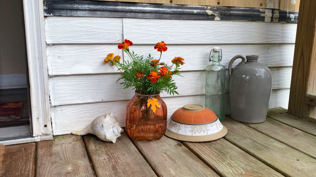 Fall porch decor orange vase and orange flowers