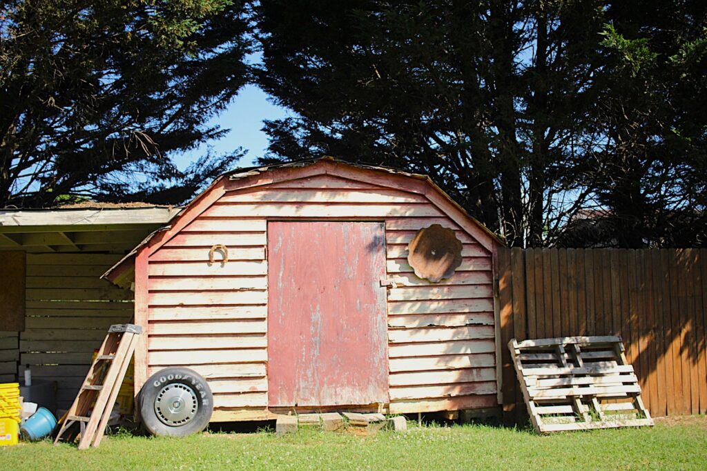 an old poor wood storage house  with trash 