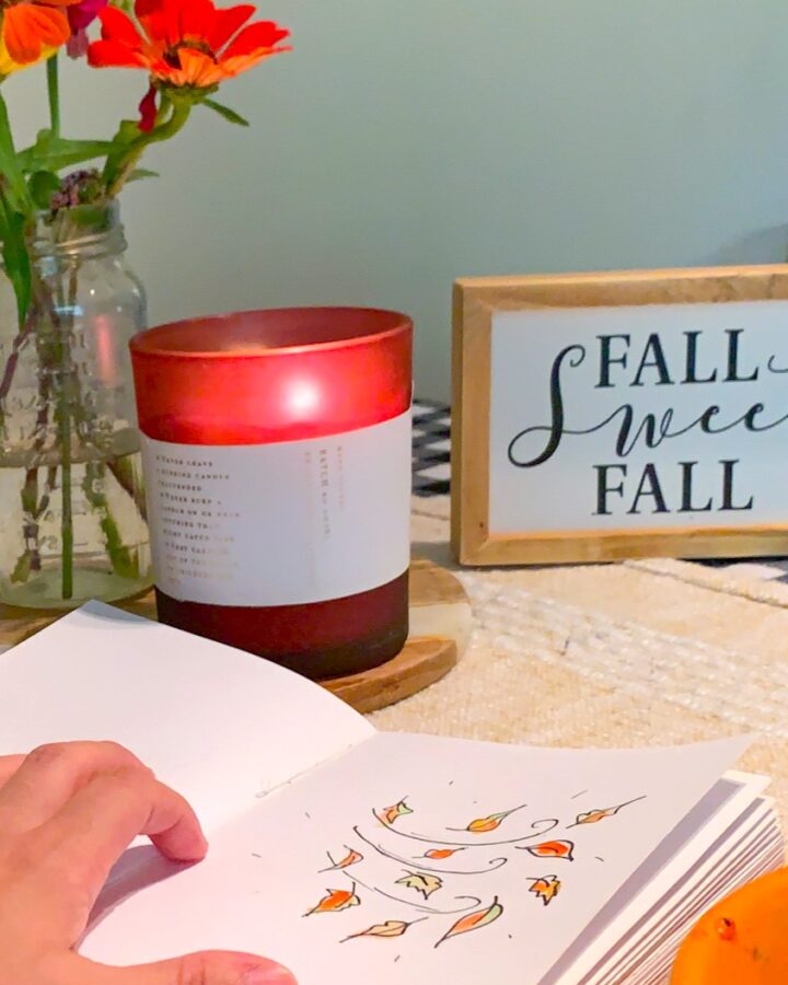 fall candle and drawing of leaves and wind